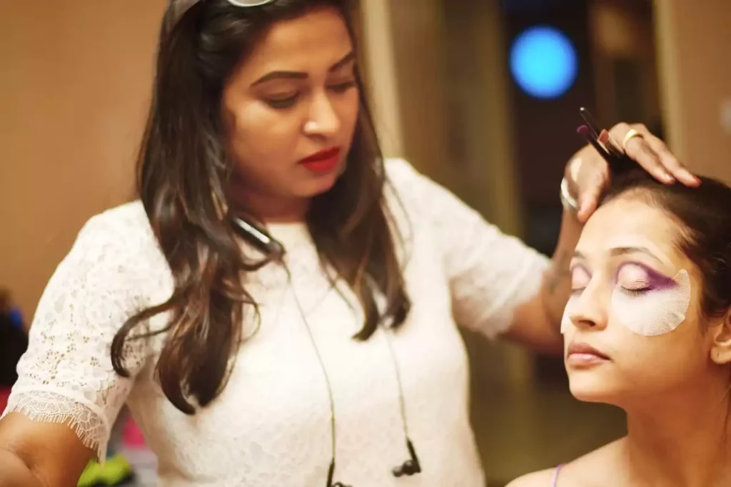 Female makeup artist Ahalya raj doing makeup to girl