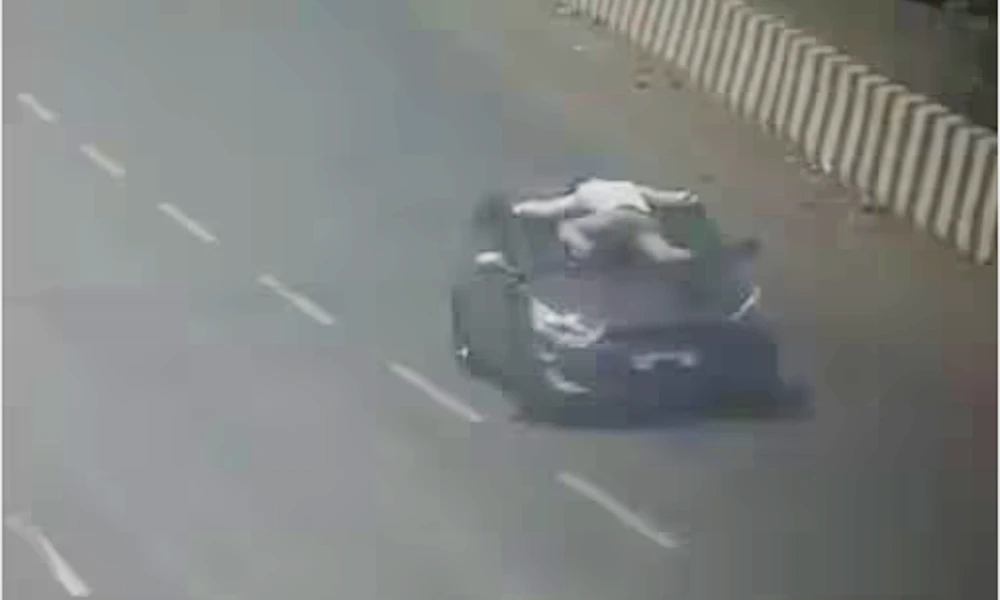 traffic cop dragged on top car's bonnet, viral video