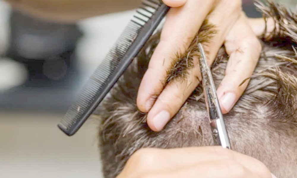 teacher chops hair in Assam