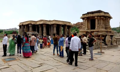 Tourists viewing the famous stone chariot of Hampi