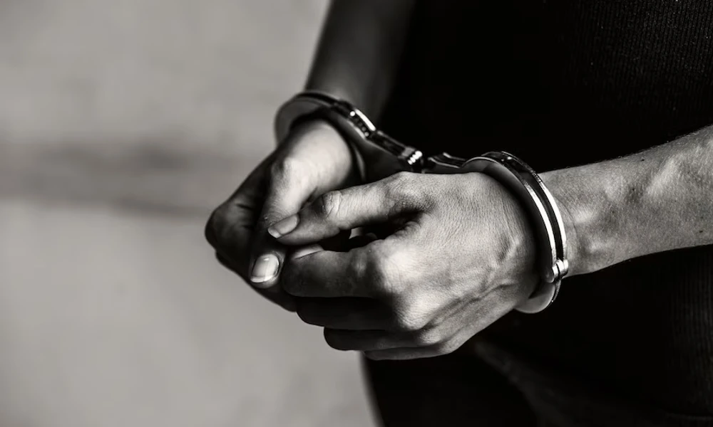 Image of Hand handcuffed man