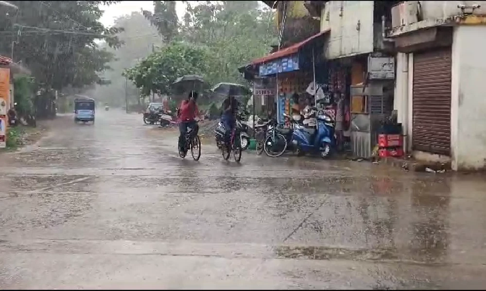 Heavy Rain in karwar students riding in bicycle