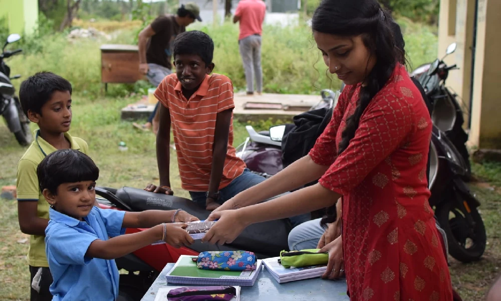 Distribution of books to children by the Bharavase team