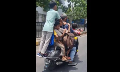 man riding scooty with 7 kids