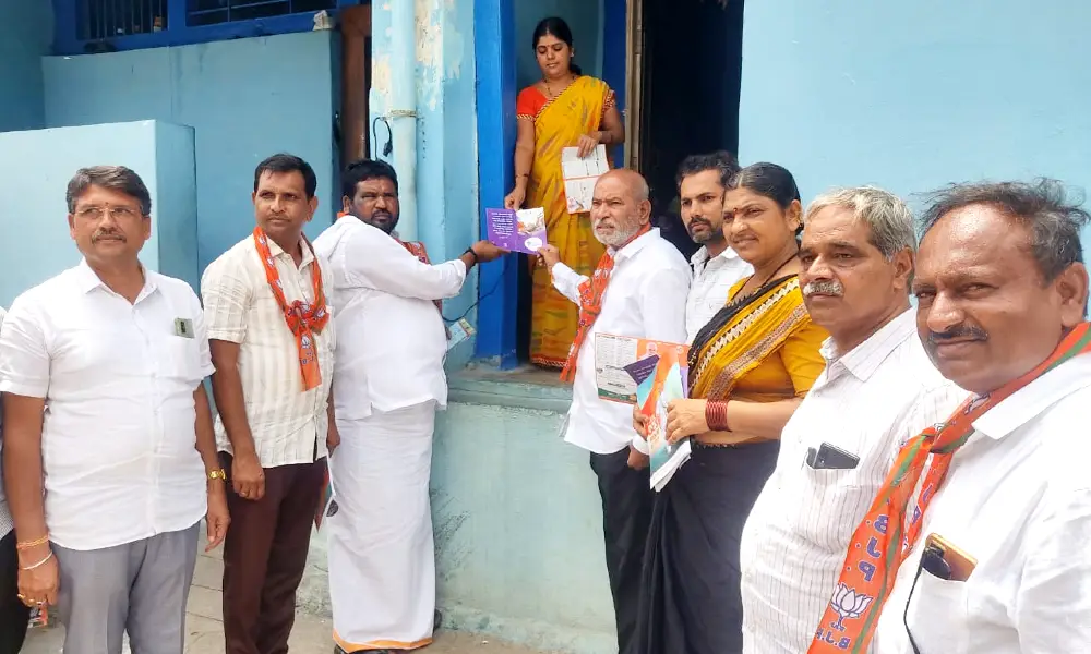 Door to door campaign about the 9 year achievement of the central government at Karatagi