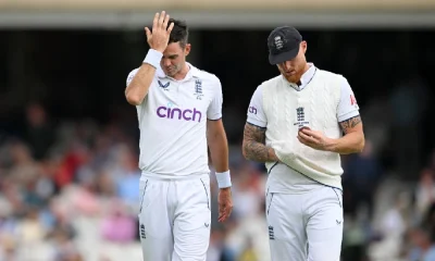 James Anderson and Ben Stokes chat at the top of his mark