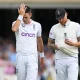 James Anderson and Ben Stokes chat at the top of his mark
