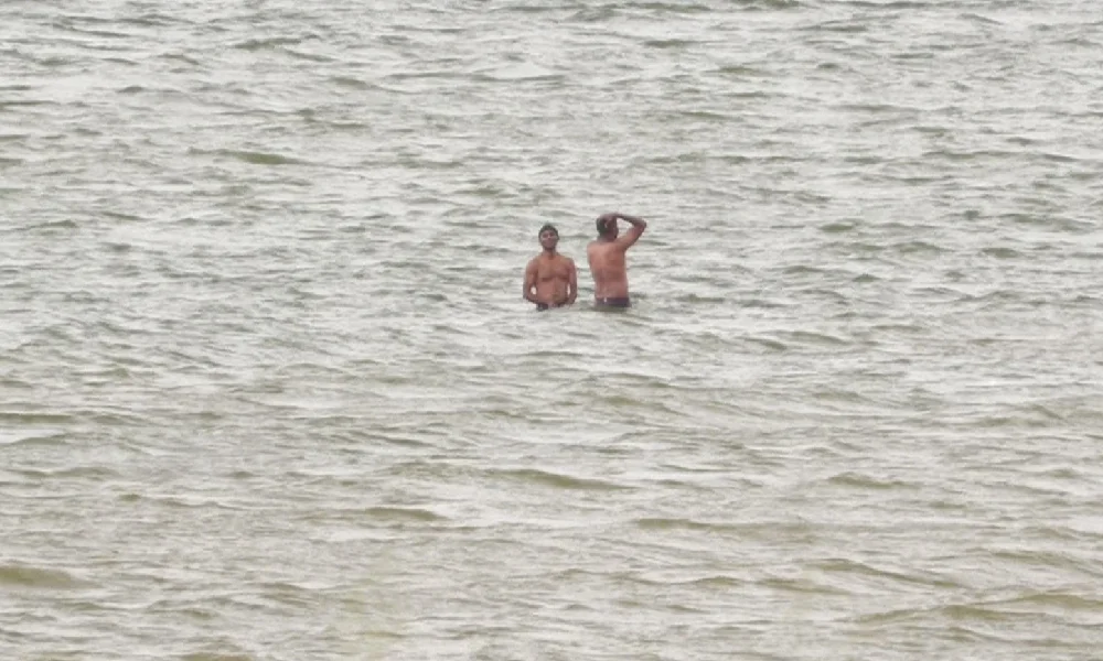Tourists swim in krs backwaters 