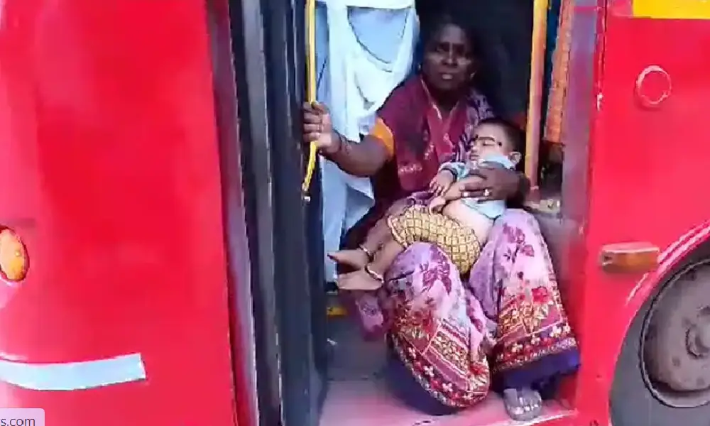 Woman sitting in bus step