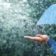 blue umbrella under heavy rain
