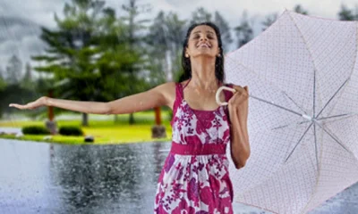 Woman with umbrella enjoying the rain