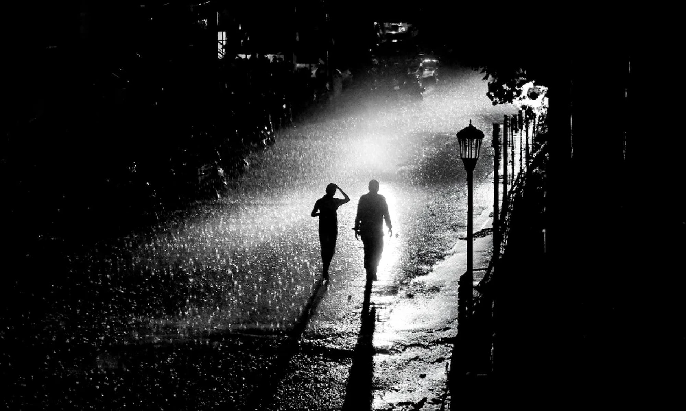 People Walking on Street in Rain at Night