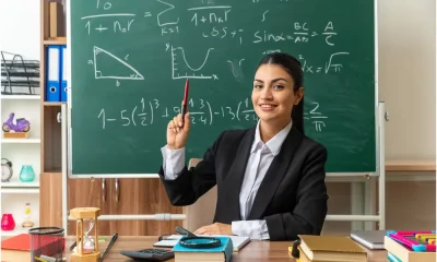 Teacher infront of blackboard