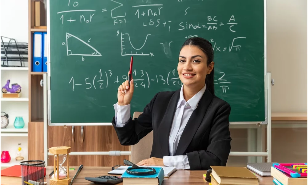 Teacher infront of blackboard