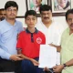 Minister Zameer Ahmed Khan helps international karate player boy