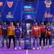 pro kabaddi team captains standing in front of trophy