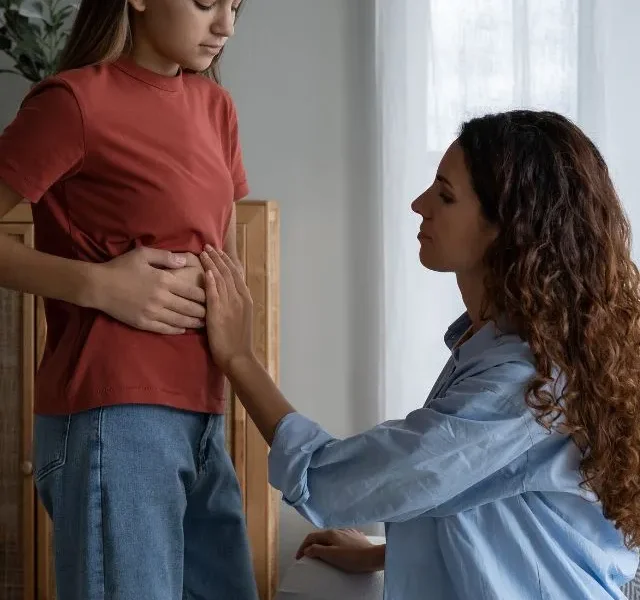 Concerned Mother Parent Examining Child Stomach at Home Child Complaining of Tummy Pain to Mom Stomach Bloating Relief