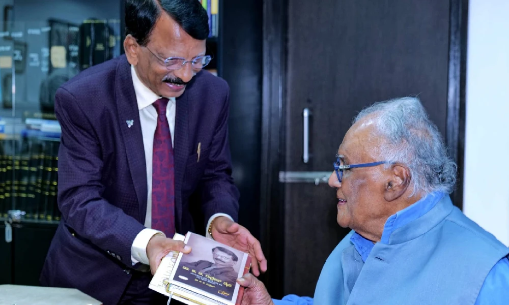 Dr BT Rudresh presents book to Prof CNR Rao