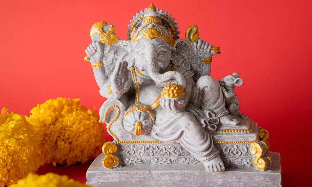 Happy Ganesh Chaturthi festival, Lord Ganesha statue with beautiful texture on red background, Ganesh is hindu god of Success.