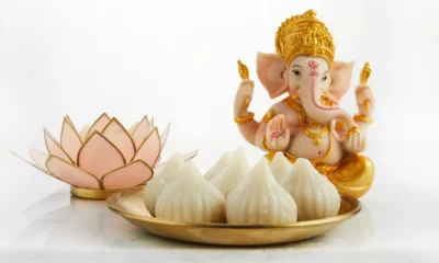 Idol of Lord Ganesha with Modak Sweet Dish and Flower. Ganesh Chaturthi
