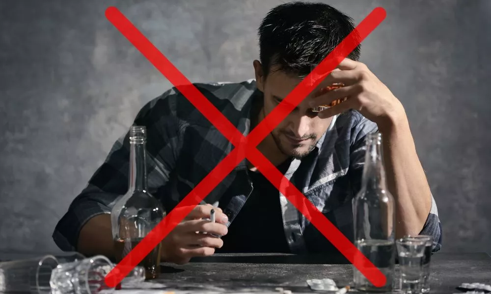 Man Drinking Alcohol and Smoking Cigarette