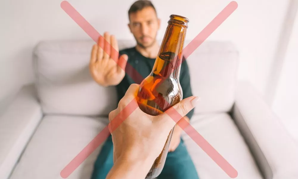 No alcohol. Young man refuses to drink beer. Stop drinking. Say no to alcoholism. Treatment of alcohol addiction