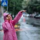 women enjoying rain in road