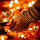 Sanatan Dharma and A woman wearing a bracelet with a candle in her hand