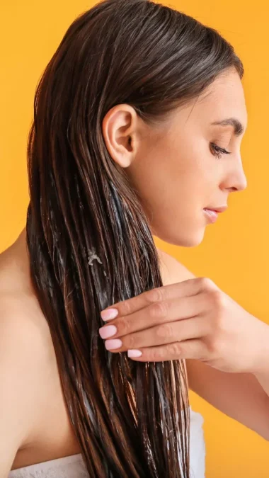 Woman Applying Coconut Oil on Hair Egg Benefits For Hair