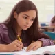 Girl student writing examination