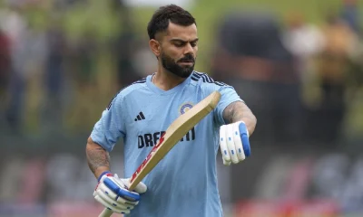 Virat Kohli walks out for a hit before the start of the game