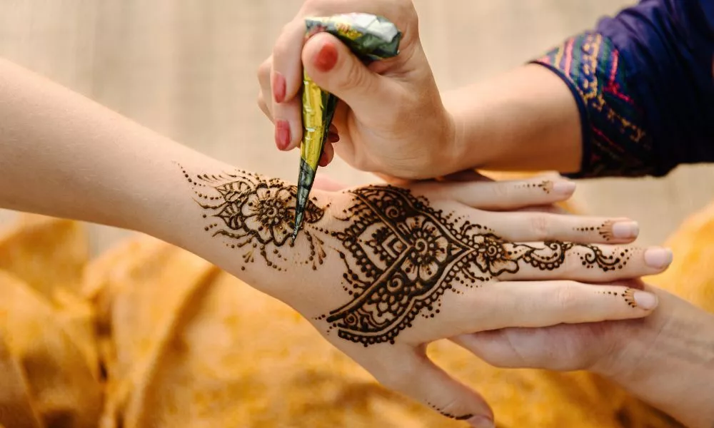 Applying Henna Tattoo on Women Hands