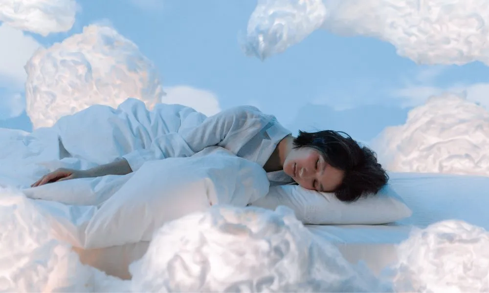 Photo of a Woman Sleeping Near Fluffy Clouds