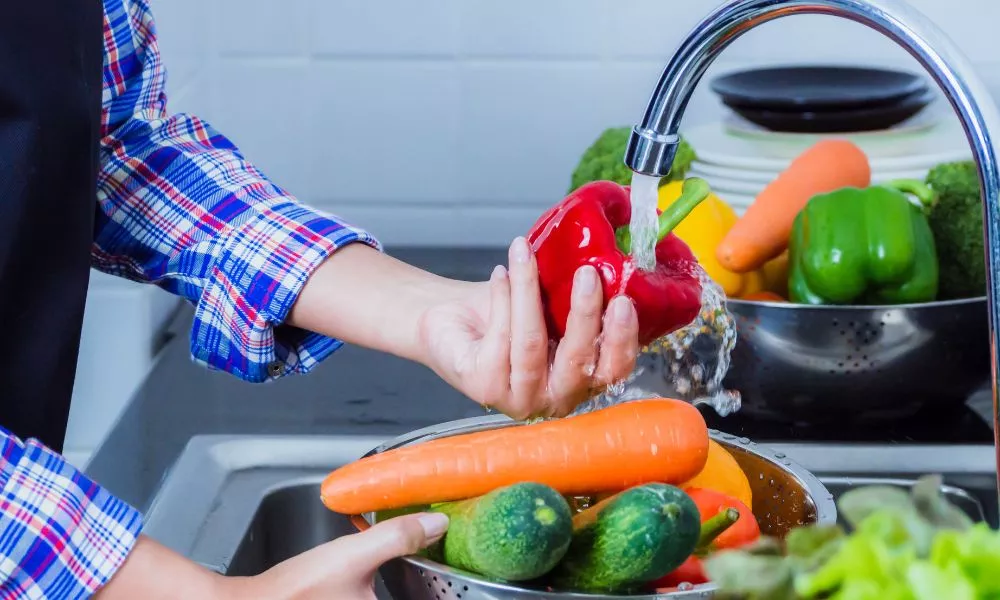 Washing fruit and vegetables to remove pesticides.