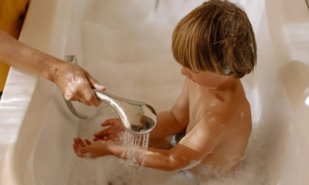 A Boy Taking a Bath in a Bathtub
