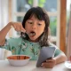 Distracted Kid Using Mobile Phone While Having Breakfast