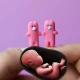 Foeticide case and pair of pink bunny figurines