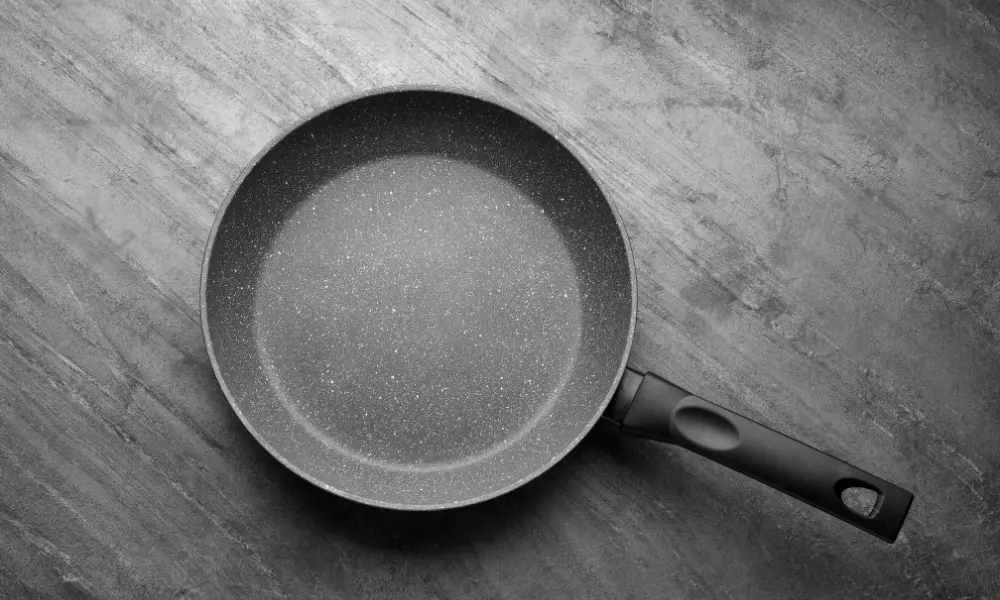 New Non-Stick Frying Pan on Grey Table, Top View