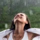 women enjoying in rain
