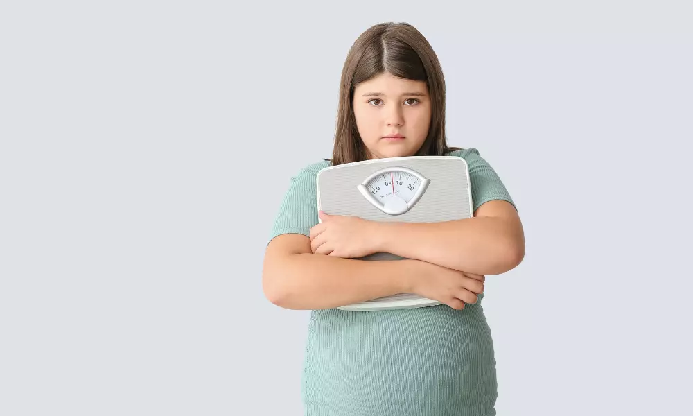Sad Overweight Girl with Measuring Scales on Light Background