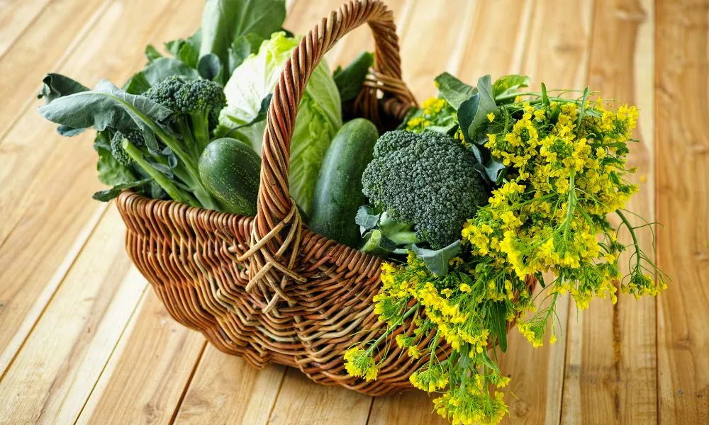 Selection of leafy green vegetables in wicker basket.