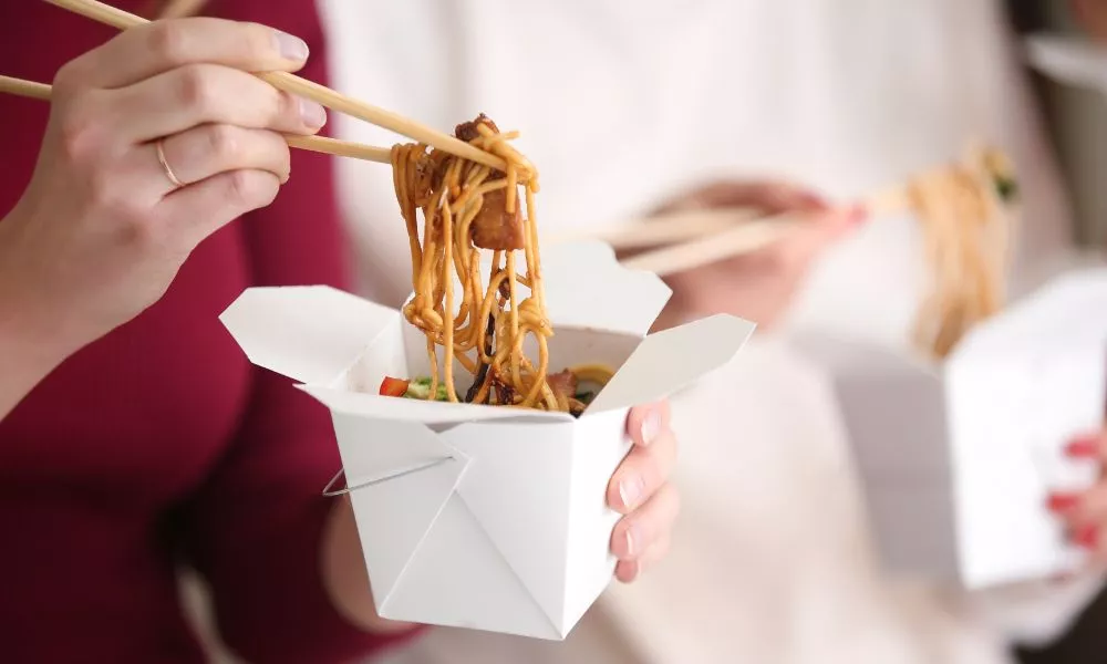 Woman Eating Chinese Noodles from Takeaway Box, Closeup
