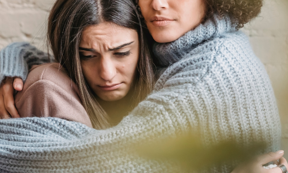 Crop woman hugging sad girlfriend