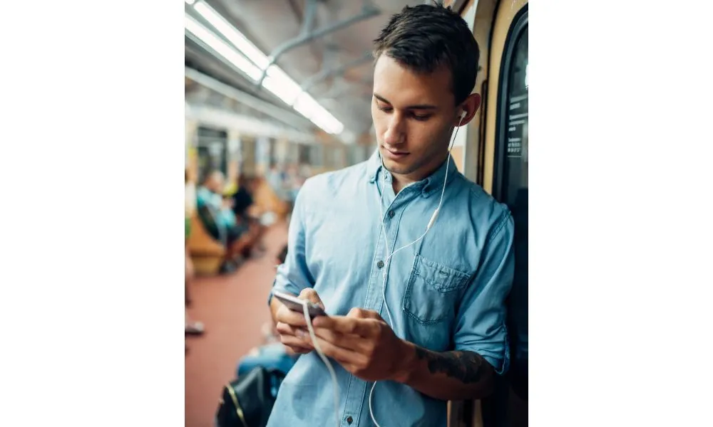 Phone Addict Man Using Gadget in Metro