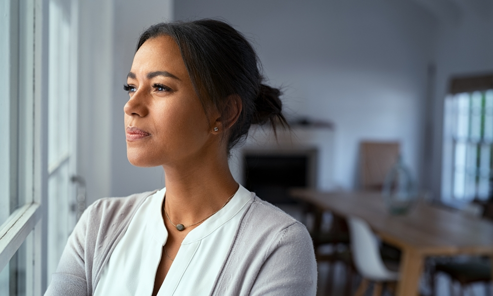 Thoughtful Woman Looking outside Window