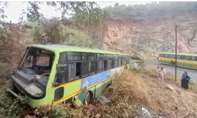 Bus skidds in rain falls into canal