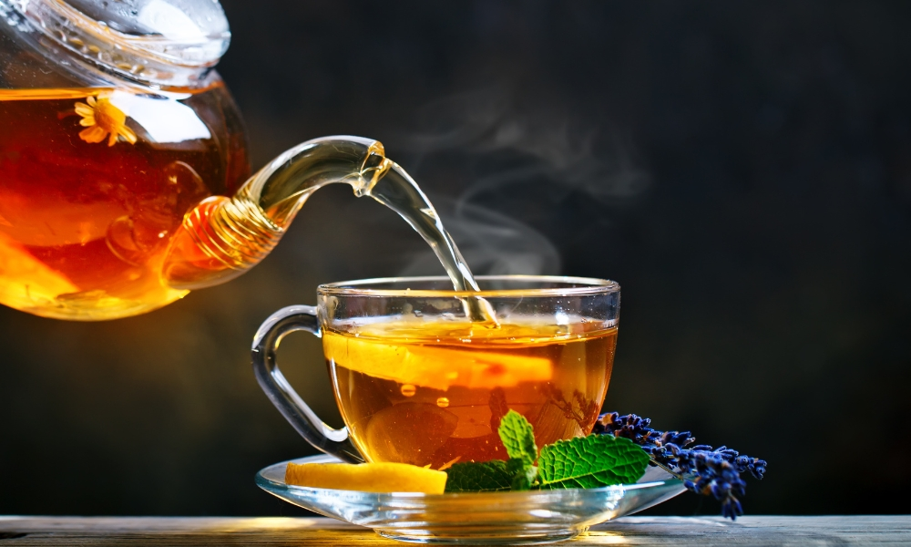 Process brewing tea,tea ceremony. Cup of freshly brewed black tea,warm soft light