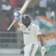 Rohit Sharma raises his bat after scoring a hundred