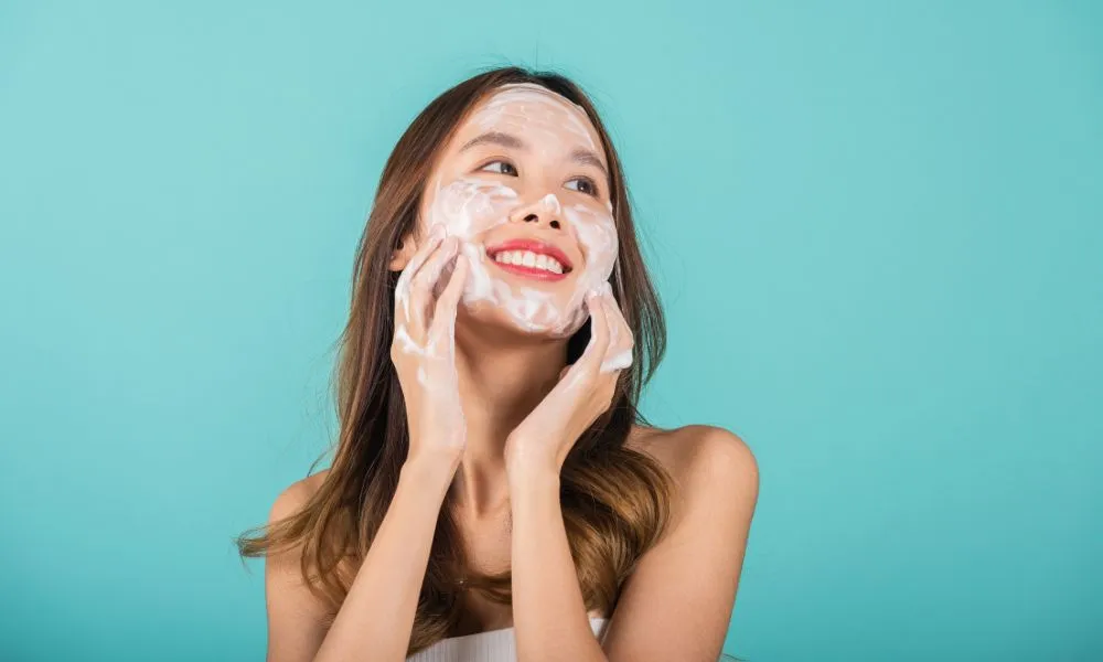 Asian woman face wash exfoliate scrub soap foam with skincare cl