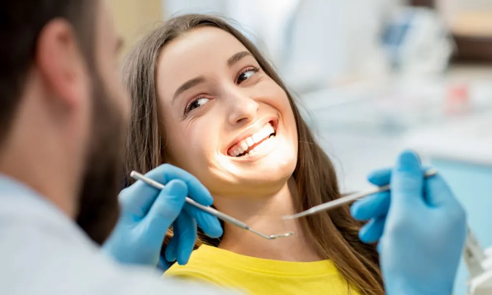 Happy female patient at the dental office